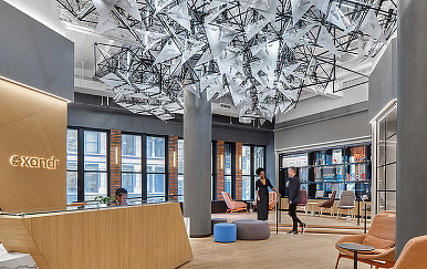 A man and woman standing in a room with a large glass ceiling.