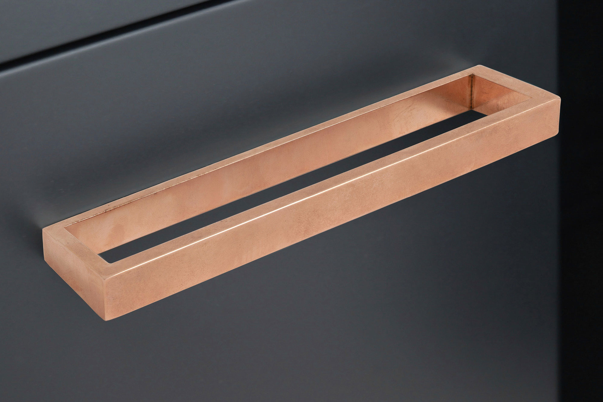 A wooden block on a black surface.
