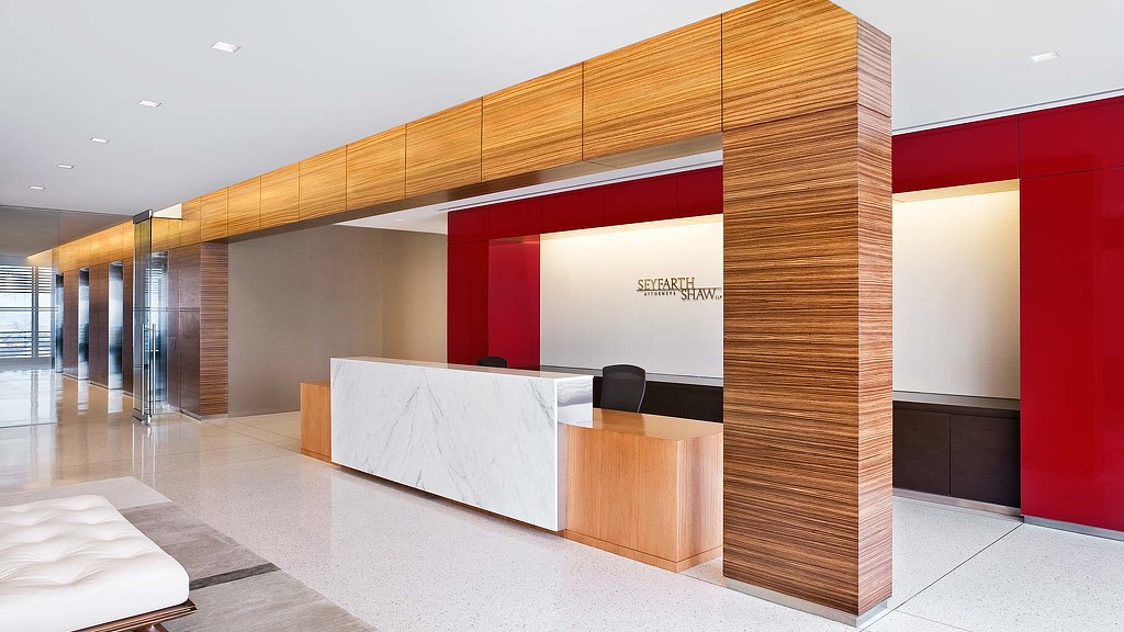 A room with a large screen and a table.