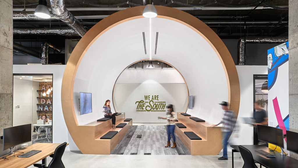 A room with a large circular object and people in it.