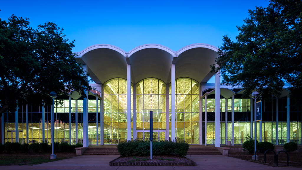 A building with columns and a fence.