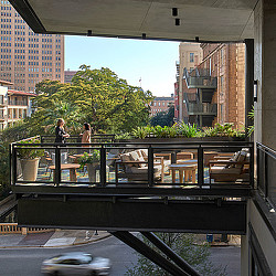 A group of people standing on a balcony.