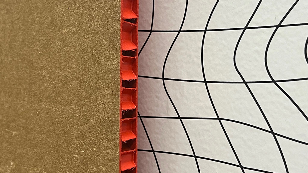 A red and black object on a tiled surface.