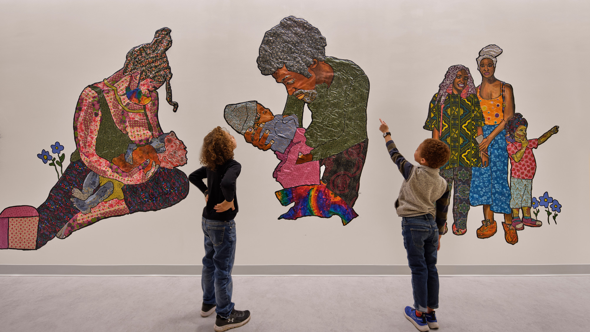 A group of people looking at a painting.