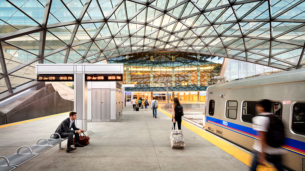 A train station with people waiting.