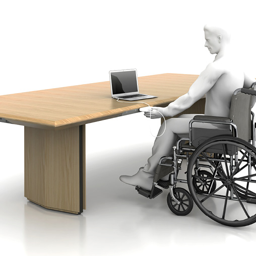 A person in a wheelchair at a desk.