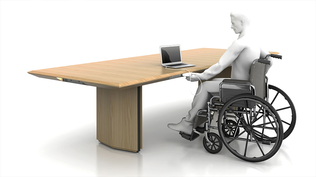 A person in a wheelchair at a Nucraft desk.