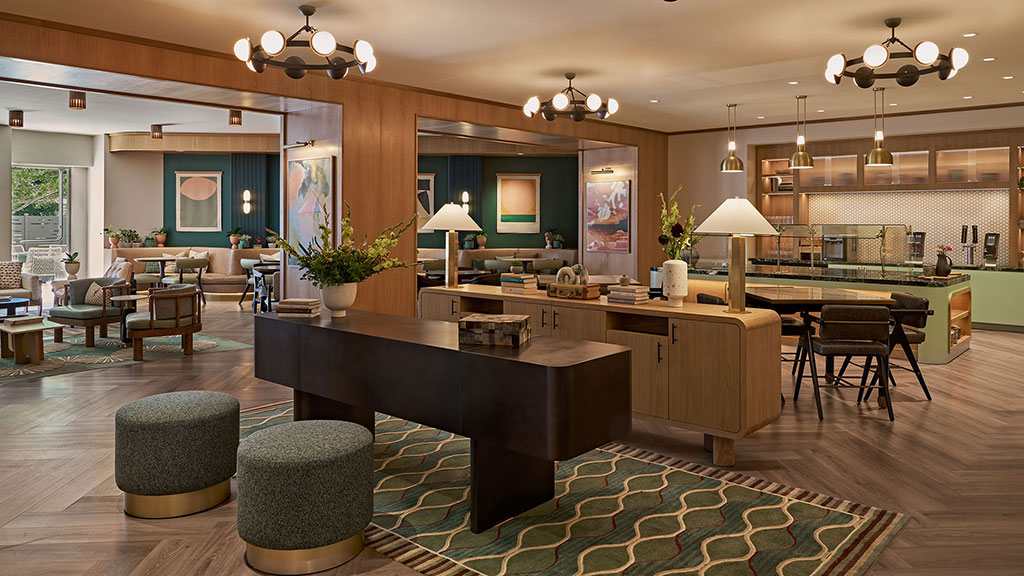A large kitchen with a bar and chairs.