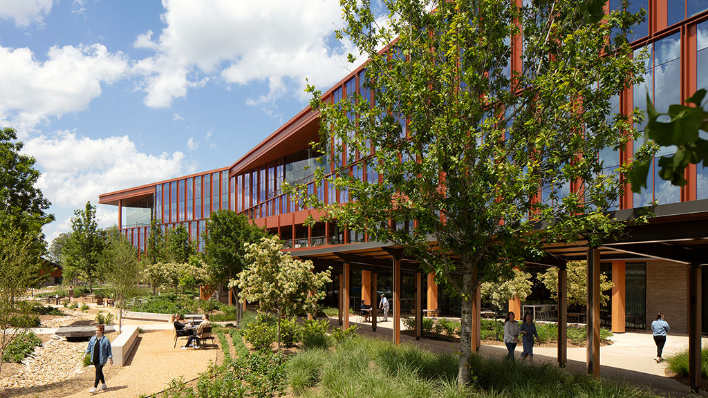 A building with a tree in front.
